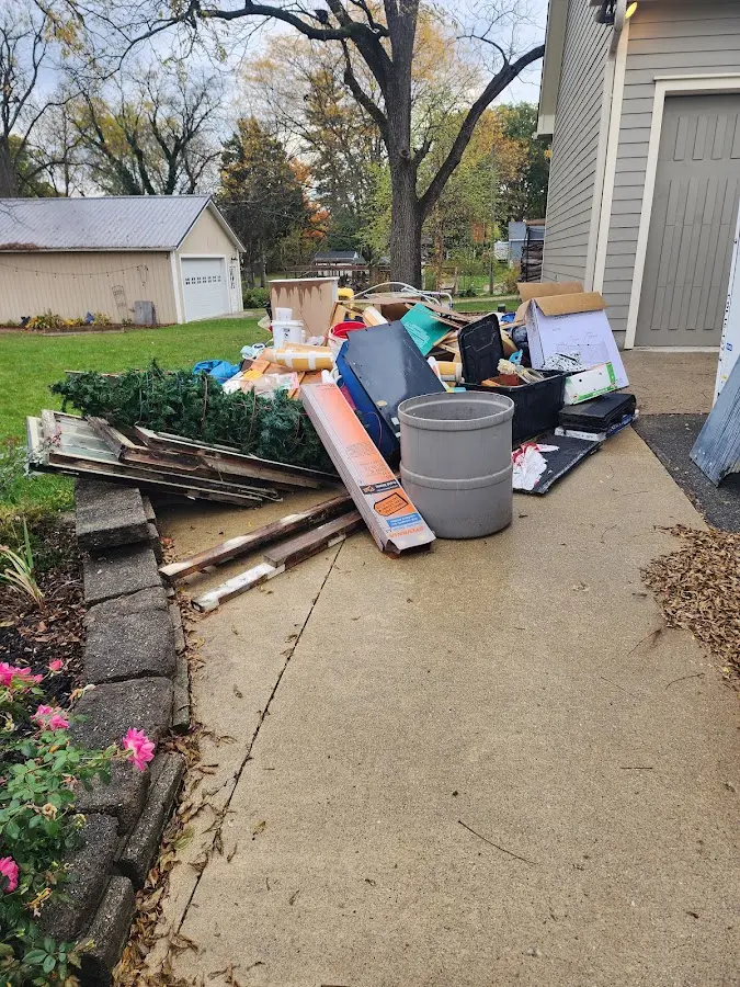 Dumpster being loaded with debris for Estate Cleanout Dumpster Rental in Pottsville